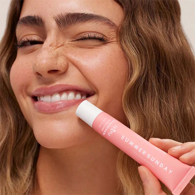 LANBENA Summer Lip Balm for Smooth Lips in a Pink Tube with a Model Smiling Radiantly